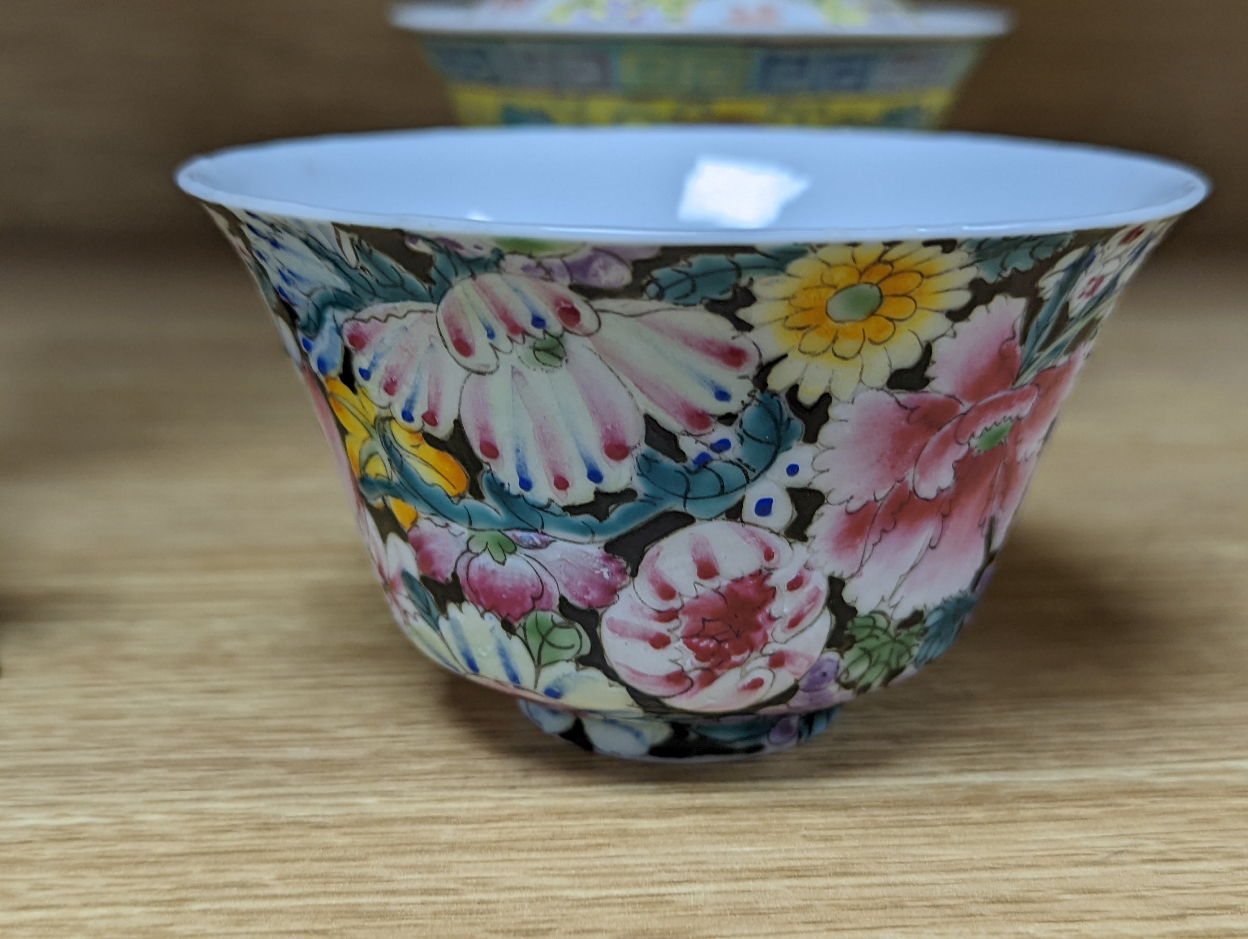 A pair of Chinese enamelled porcelain rice bowls, covers and stands and an odd bowl